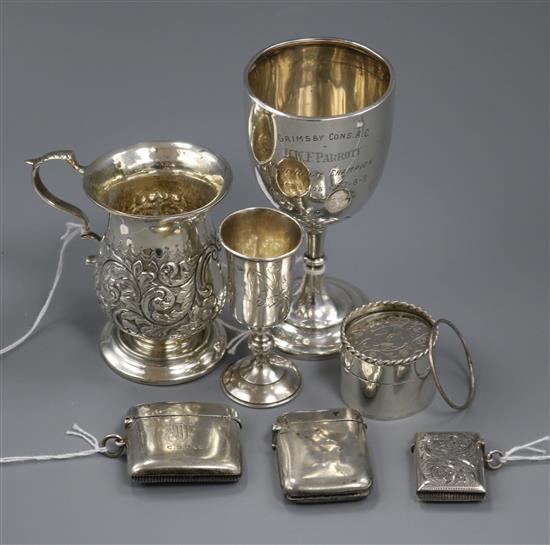 Three silver vestas, a modern cylindrical box, a Russian silver kiddush cup, a mug and a trophy cup